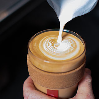 Milk being poured into coffee